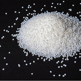 Schmelzkleber in Granulatform auf schwarzem Untergrund | Abifor